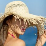 woman in straw hat to protect her skin from the sun